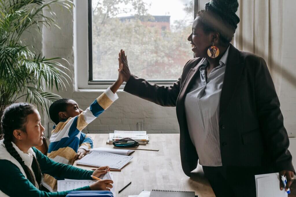 Educator gives high 5 to students